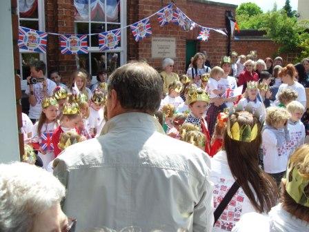Childrn with Jubilee Queen and Consort singing National Anthem